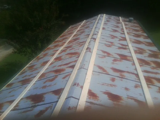 Rusted metal roof panels with new wood purlins before replacement — Storm Damage Roof Repair in Waterville by Roofing Brothers